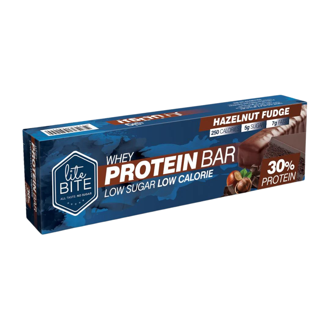 Front packaging of Lite Bite Whey Protein Bar Hazelnut Fudge 70g, featuring a chocolate-coated hazelnut fudge bar with whole hazelnuts, labeled 30% protein, low sugar, and low calorie.