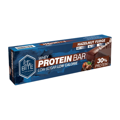 Front packaging of Lite Bite Whey Protein Bar Hazelnut Fudge 70g, featuring a chocolate-coated hazelnut fudge bar with whole hazelnuts, labeled 30% protein, low sugar, and low calorie.